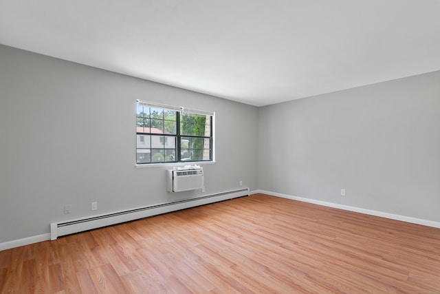 37 Enid St Apt C, Bridgeport, CT 06606 - spare room featuring a baseboard heating unit, light wood finished floors, and an AC wall unit