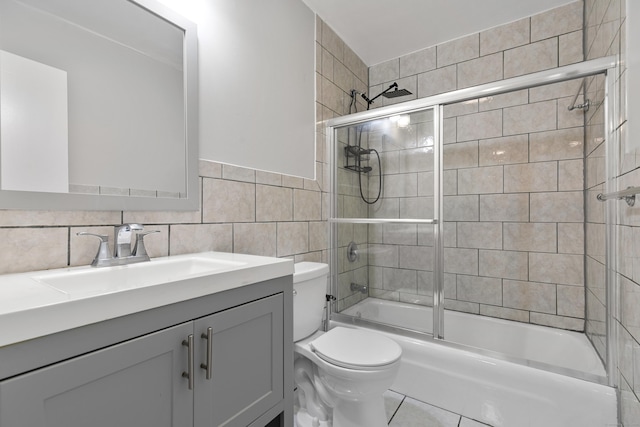 37 Enid St Apt C, Bridgeport, CT 06606 - bathroom with vanity, shower / bath combination with glass door, and tile walls