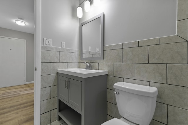 37 Enid St Apt C, Bridgeport, CT 06606 - half bath featuring tile walls, vanity, and wood finished floors