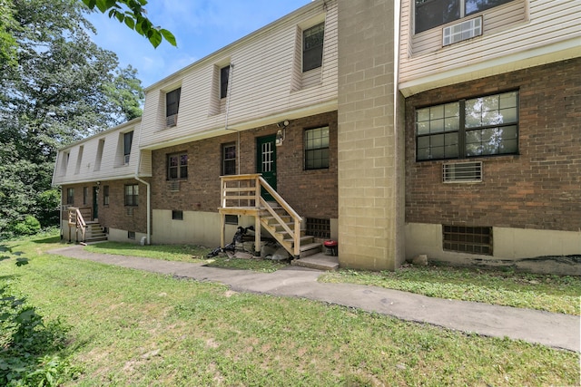 37 Enid St Apt C, Bridgeport, CT 06606 - rear view of house with brick siding and a yard