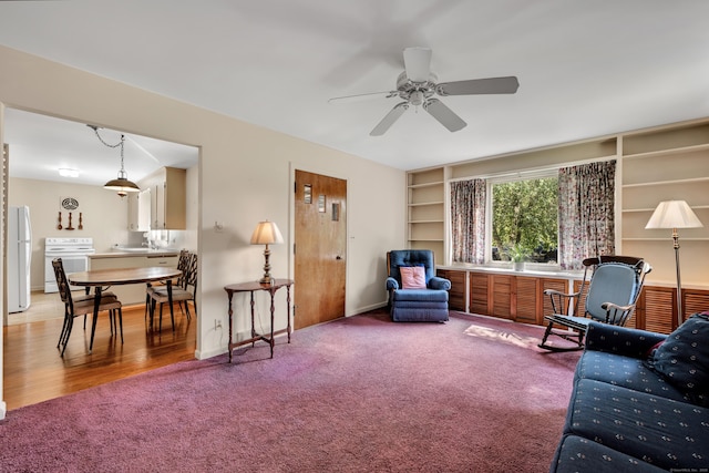 33 Hazel Ave, Naugatuck, CT 06770 - living area with light carpet, ceiling fan, and built in shelves