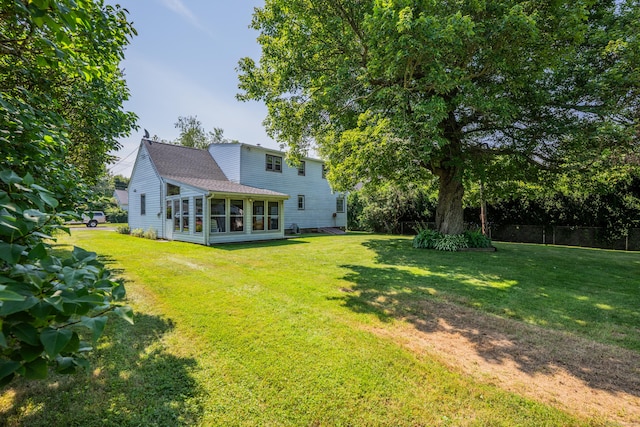 33 Hazel Ave, Naugatuck, CT 06770 - back of house featuring a sunroom, a yard, and roof with shingles