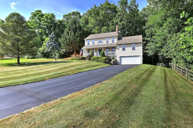 67 Nicole Dr, Naugatuck, CT 06770 - colonial-style house featuring driveway, an attached garage, covered porch, and a chimney
