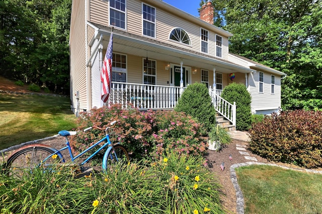 67 Nicole Dr, Naugatuck, CT 06770 - view of front facade featuring covered porch, a chimney, and a front lawn