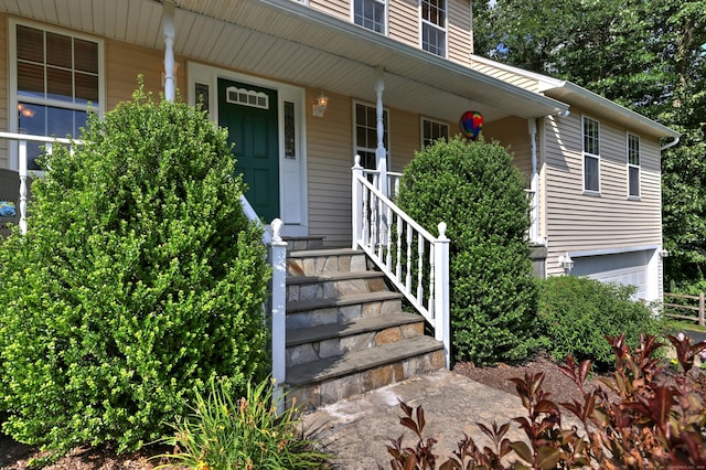 67 Nicole Dr, Naugatuck, CT 06770 - view of exterior entry with a porch and an attached garage