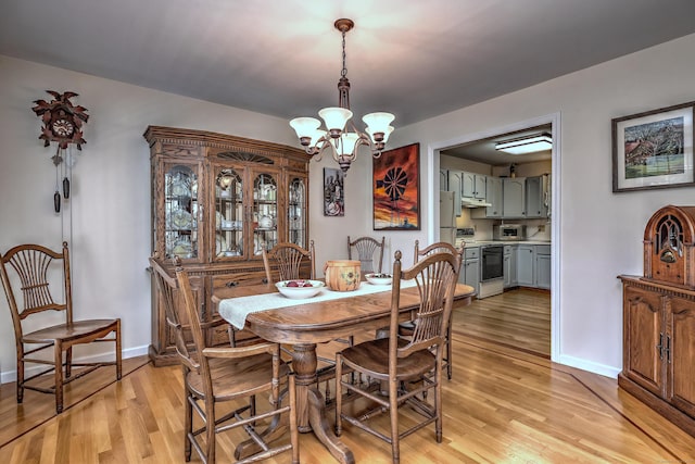 67 Nicole Dr, Naugatuck, CT 06770 - dining area featuring a chandelier and light wood-style flooring