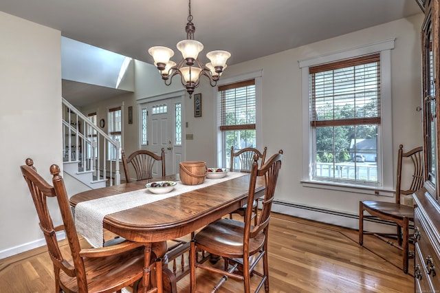67 Nicole Dr, Naugatuck, CT 06770 - dining space featuring light wood finished floors, stairs, a chandelier, and baseboard heating