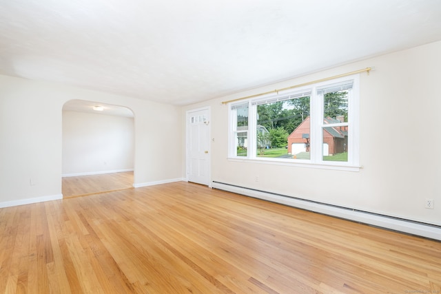 51 Euston St, New Britain, CT 06053 - unfurnished room featuring arched walkways, a baseboard radiator, and light wood-style floors