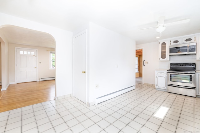 51 Euston St, New Britain, CT 06053 - kitchen with stainless steel appliances, arched walkways, baseboard heating, and white cabinetry