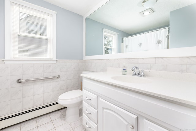 51 Euston St, New Britain, CT 06053 - bathroom featuring a baseboard heating unit, vanity, tile patterned floors, tile walls, and a wainscoted wall
