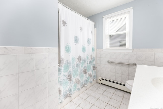 51 Euston St, New Britain, CT 06053 - bathroom with baseboard heating, tile walls, tile patterned floors, vanity, and a shower with curtain