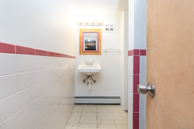 51 Euston St, New Britain, CT 06053 - bathroom featuring baseboard heating, tile patterned floors, and tile walls