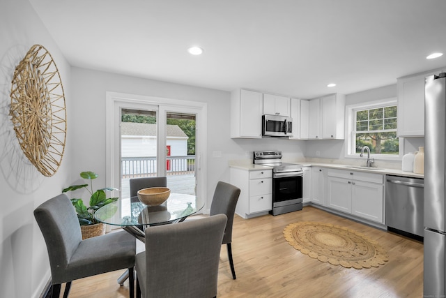 64 Ridgefield Rd, Wallingford, CT 06492 - kitchen featuring stainless steel appliances, light countertops, white cabinets, light wood finished floors, and recessed lighting