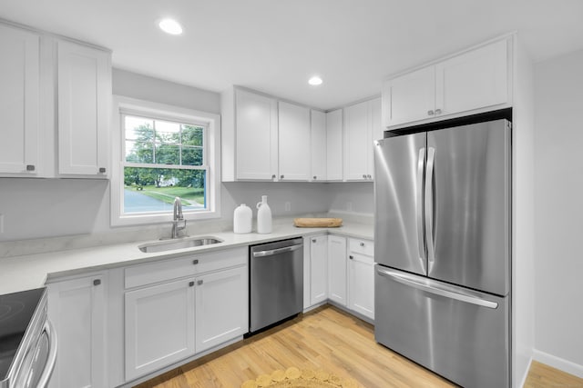 64 Ridgefield Rd, Wallingford, CT 06492 - kitchen with stainless steel appliances, white cabinetry, light countertops, light wood finished floors, and recessed lighting