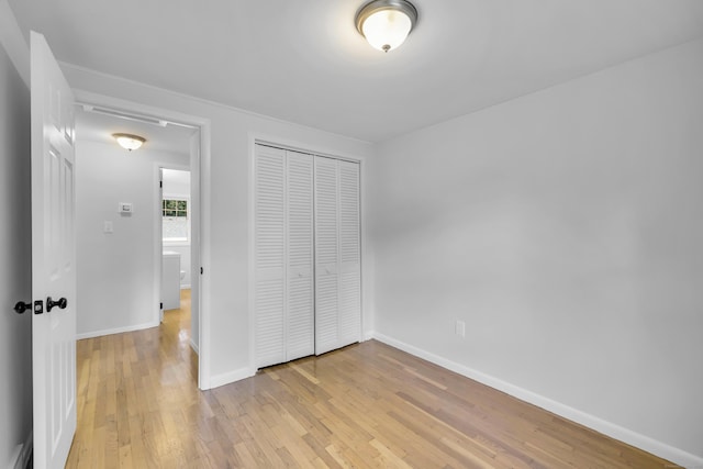 64 Ridgefield Rd, Wallingford, CT 06492 - unfurnished bedroom featuring light wood-style floors and a closet