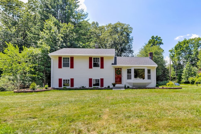 64 Ridgefield Rd, Wallingford, CT 06492 - tri-level home with a chimney, a front lawn, and entry steps