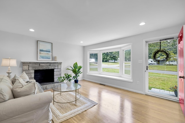 64 Ridgefield Rd, Wallingford, CT 06492 - living room with wood finished floors, recessed lighting, and a stone fireplace