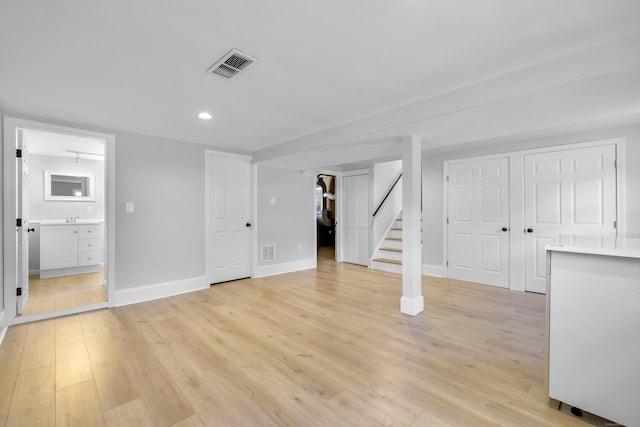 64 Ridgefield Rd, Wallingford, CT 06492 - below grade area with stairs, light wood-style flooring, and recessed lighting