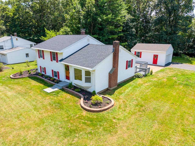 64 Ridgefield Rd, Wallingford, CT 06492 - view of front facade featuring roof with shingles, an outdoor structure, a chimney, and a front lawn