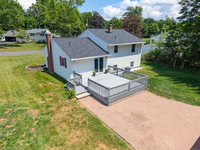 64 Ridgefield Rd, Wallingford, CT 06492 - rear view of property with a chimney, a shingled roof, a lawn, a wooden deck, and view of wooded area