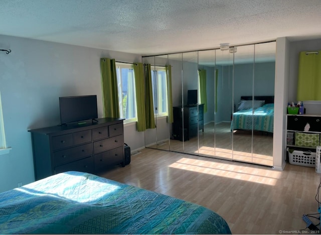 122 Trolley Crossing Ln Unit 122, Middletown, CT 06457 - bedroom with wood finished floors and a textured ceiling