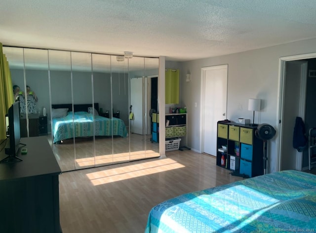 122 Trolley Crossing Ln Unit 122, Middletown, CT 06457 - bedroom featuring wood finished floors and a textured ceiling