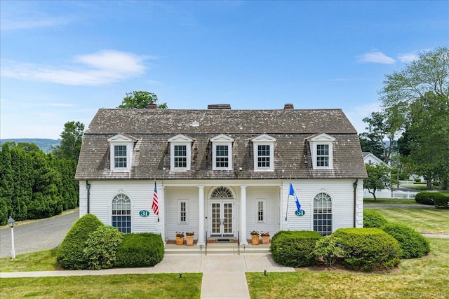 31 N Main St, Essex, CT 06426 - view of front facade with a gambrel roof, a chimney, and french doors