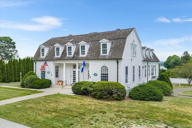 31 N Main St, Essex, CT 06426 - view of front of house with a front yard, a gambrel roof, and a porch