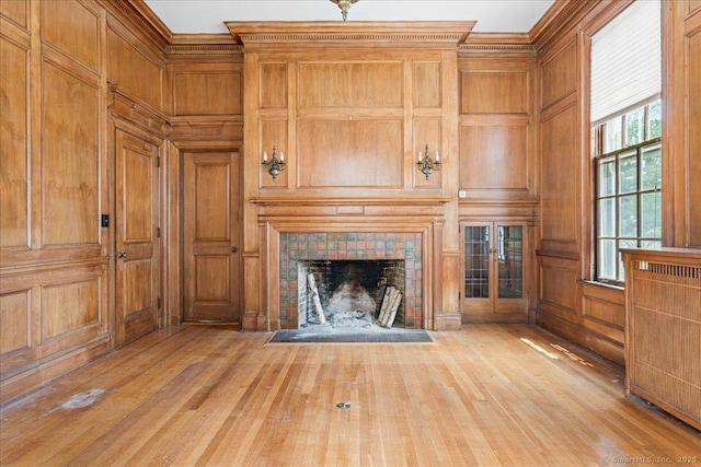 31 N Main St, Essex, CT 06426 - unfurnished living room featuring a tile fireplace, wood finished floors, crown molding, and wood walls