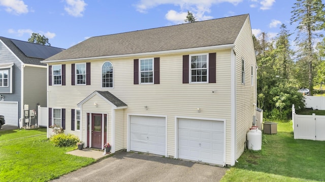20 Society Hill Rd, Waterbury, CT 06704 - view of front of house featuring an attached garage, driveway, a front yard, and roof with shingles