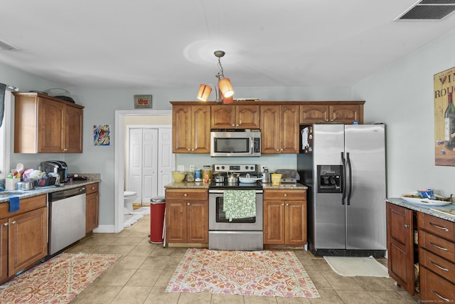 20 Society Hill Rd, Waterbury, CT 06704 - kitchen featuring stainless steel appliances, light tile patterned floors, and brown cabinetry