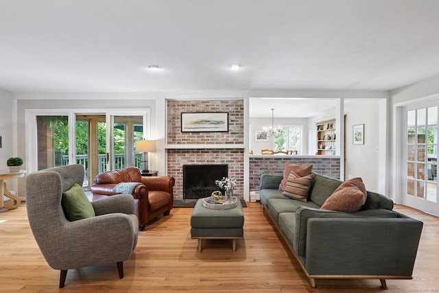 223 N St, Ridgefield, CT 06877 - living area featuring light wood finished floors, a chandelier, and a fireplace