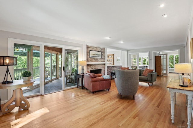 223 N St, Ridgefield, CT 06877 - living room featuring light wood-type flooring and a brick fireplace