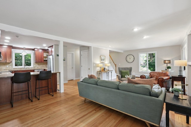 223 N St, Ridgefield, CT 06877 - living room with light wood-type flooring, stairs, plenty of natural light, and recessed lighting