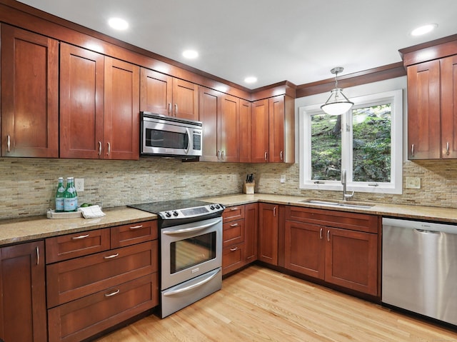 223 N St, Ridgefield, CT 06877 - kitchen with stainless steel appliances, light wood-style floors, tasteful backsplash, light stone counters, and recessed lighting
