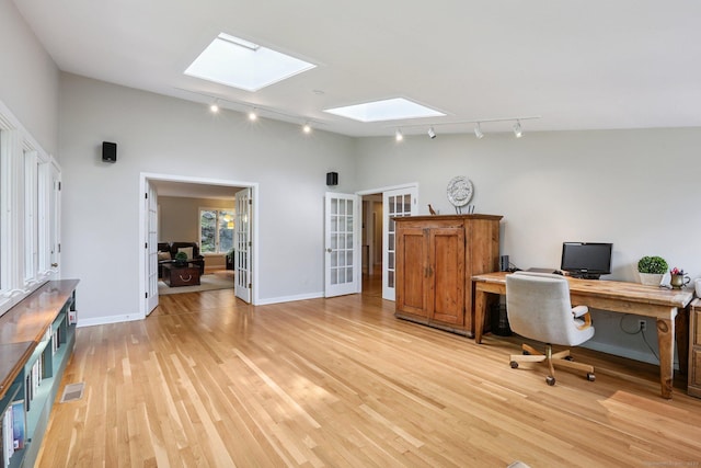 223 N St, Ridgefield, CT 06877 - office with track lighting, a skylight, french doors, light wood-style floors, and a towering ceiling