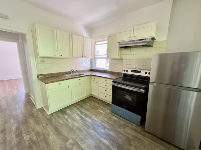 310 Bond St, Bridgeport, CT 06610 - kitchen featuring freestanding refrigerator, range with electric stovetop, dark countertops, and backsplash