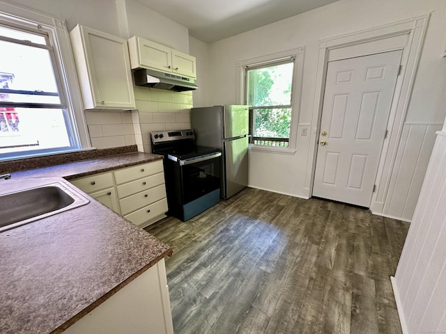 310 Bond St, Bridgeport, CT 06610 - kitchen with stainless steel electric range, dark wood finished floors, under cabinet range hood, dark countertops, and decorative backsplash