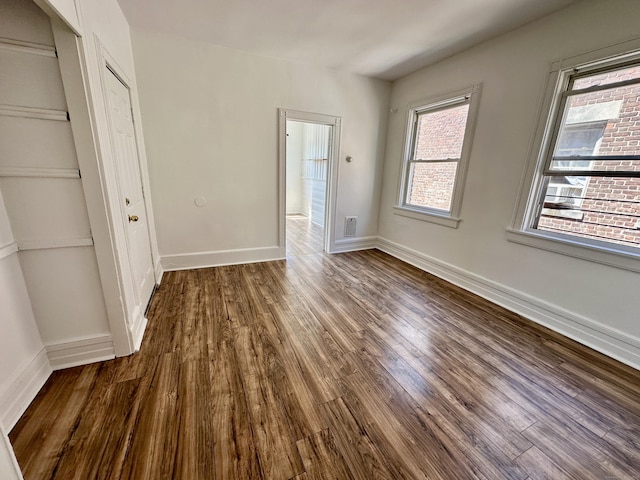 310 Bond St, Bridgeport, CT 06610 - unfurnished bedroom featuring dark wood-style flooring and a closet