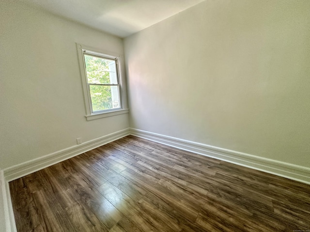 310 Bond St, Bridgeport, CT 06610 - spare room featuring dark wood-style flooring and baseboards