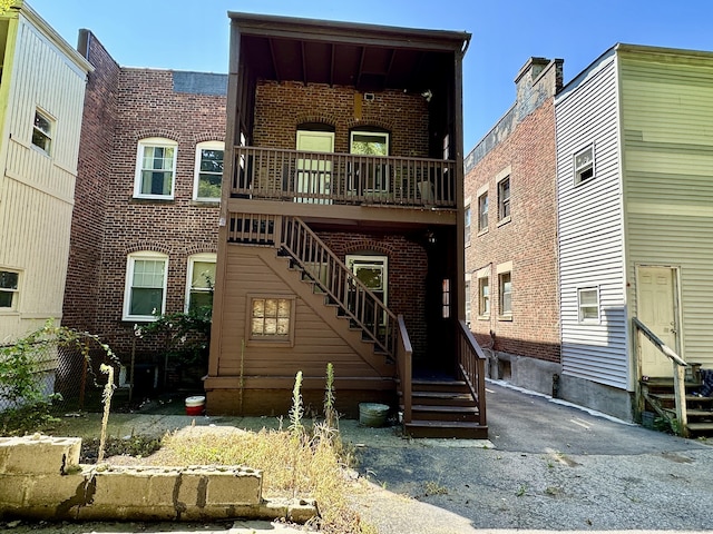 310 Bond St, Bridgeport, CT 06610 - view of front of house with brick siding, stairs, and entry steps