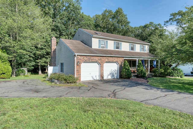 279 Annelise Ave, Southington, CT 06489 - view of front of home featuring driveway, a chimney, brick siding, a front lawn, and roof with shingles
