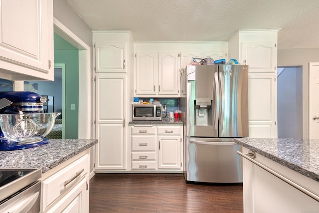 279 Annelise Ave, Southington, CT 06489 - kitchen featuring appliances with stainless steel finishes, dark wood-style floors, white cabinets, a textured ceiling, and dark stone countertops
