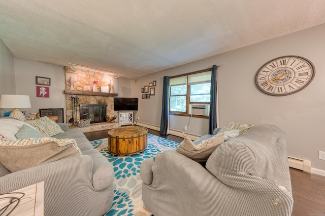 279 Annelise Ave, Southington, CT 06489 - living area featuring wood finished floors, a baseboard radiator, a fireplace, cooling unit, and a textured ceiling