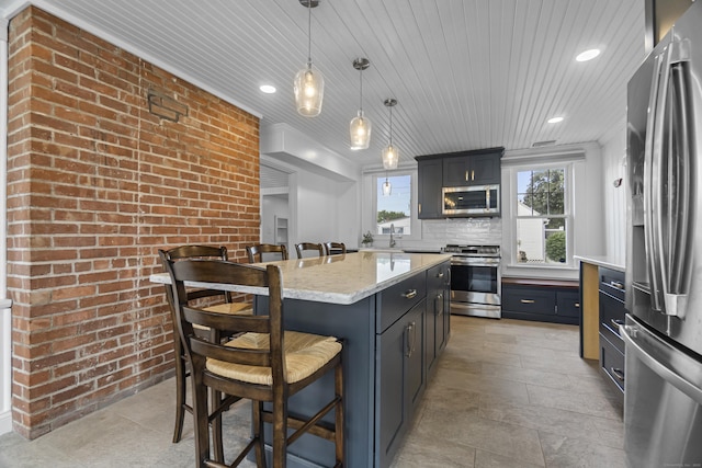 30 New Britain Rd, Old Lyme, CT 06371 - kitchen with appliances with stainless steel finishes, a kitchen bar, brick wall, hanging light fixtures, and wood ceiling