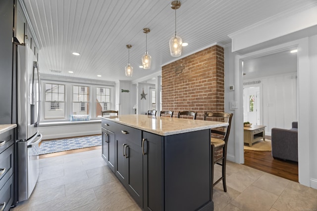 30 New Britain Rd, Old Lyme, CT 06371 - kitchen with a breakfast bar, freestanding refrigerator, pendant lighting, a center island, and light stone countertops