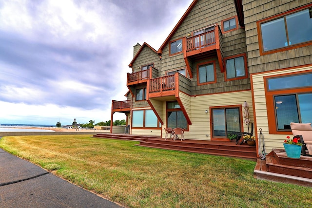2 Old Town Hwy Unit 45, East Haven, CT 06512 - rear view of house featuring a balcony, a chimney, and a lawn