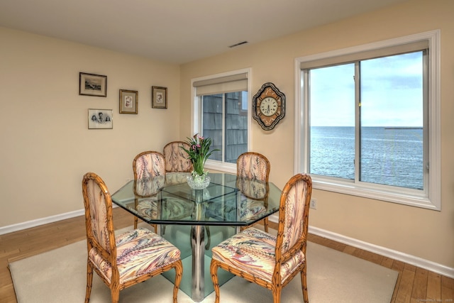 2 Old Town Hwy Unit 45, East Haven, CT 06512 - dining space featuring wood finished floors, plenty of natural light, and a water view