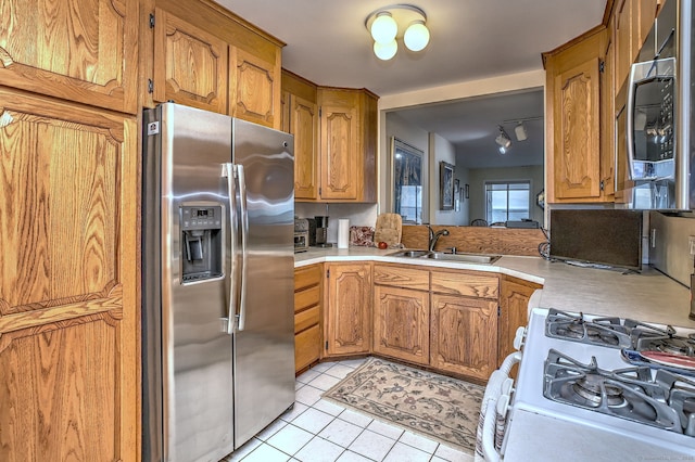 2 Old Town Hwy Unit 45, East Haven, CT 06512 - kitchen featuring appliances with stainless steel finishes, light countertops, light tile patterned flooring, and brown cabinetry