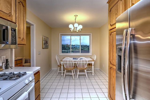 2 Old Town Hwy Unit 45, East Haven, CT 06512 - kitchen with appliances with stainless steel finishes, brown cabinetry, a chandelier, light countertops, and pendant lighting